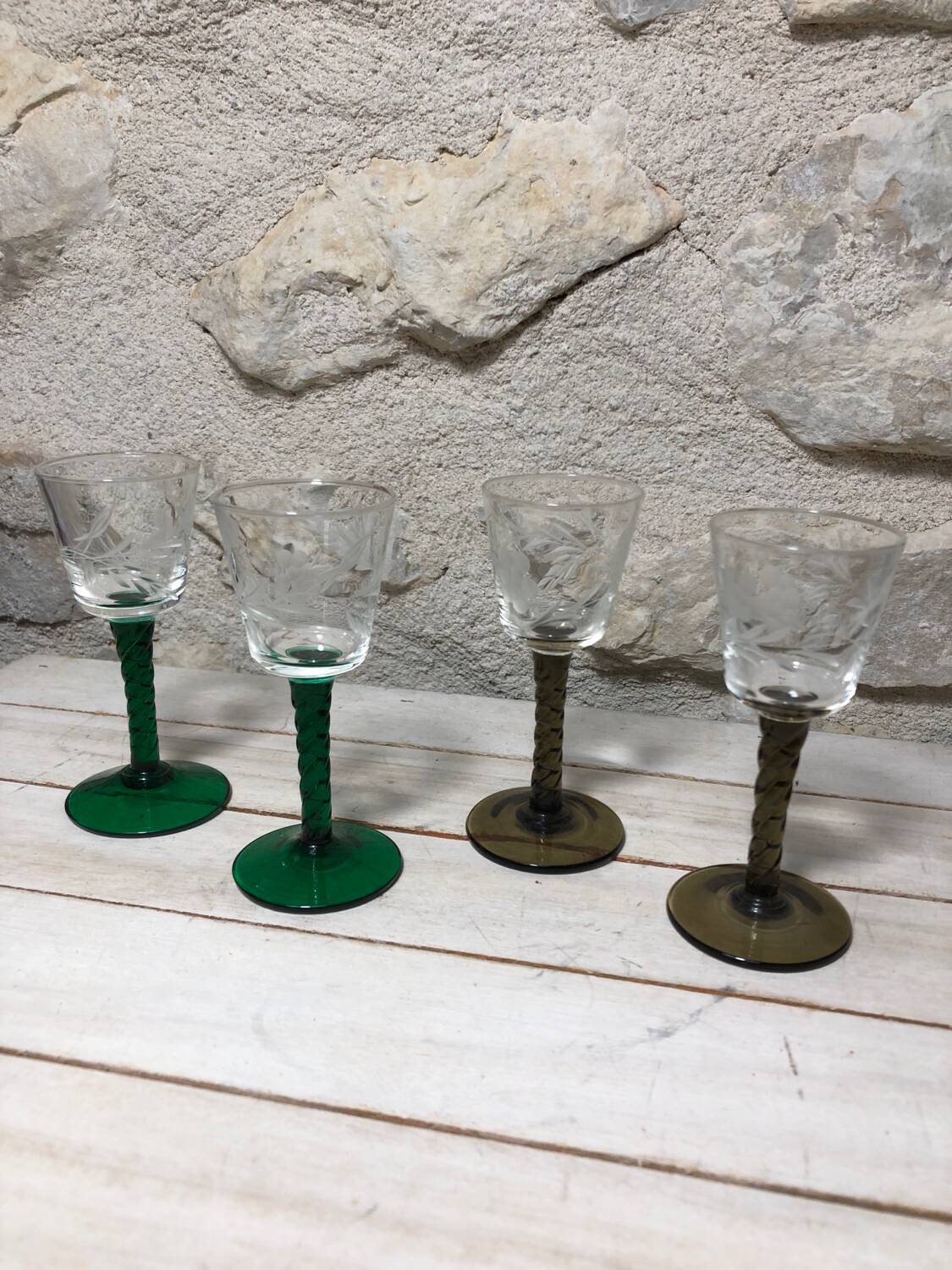 Antique and rare! Sold in a set of 12 colorful twisted stemmed glasses engraved with flowers and leaves