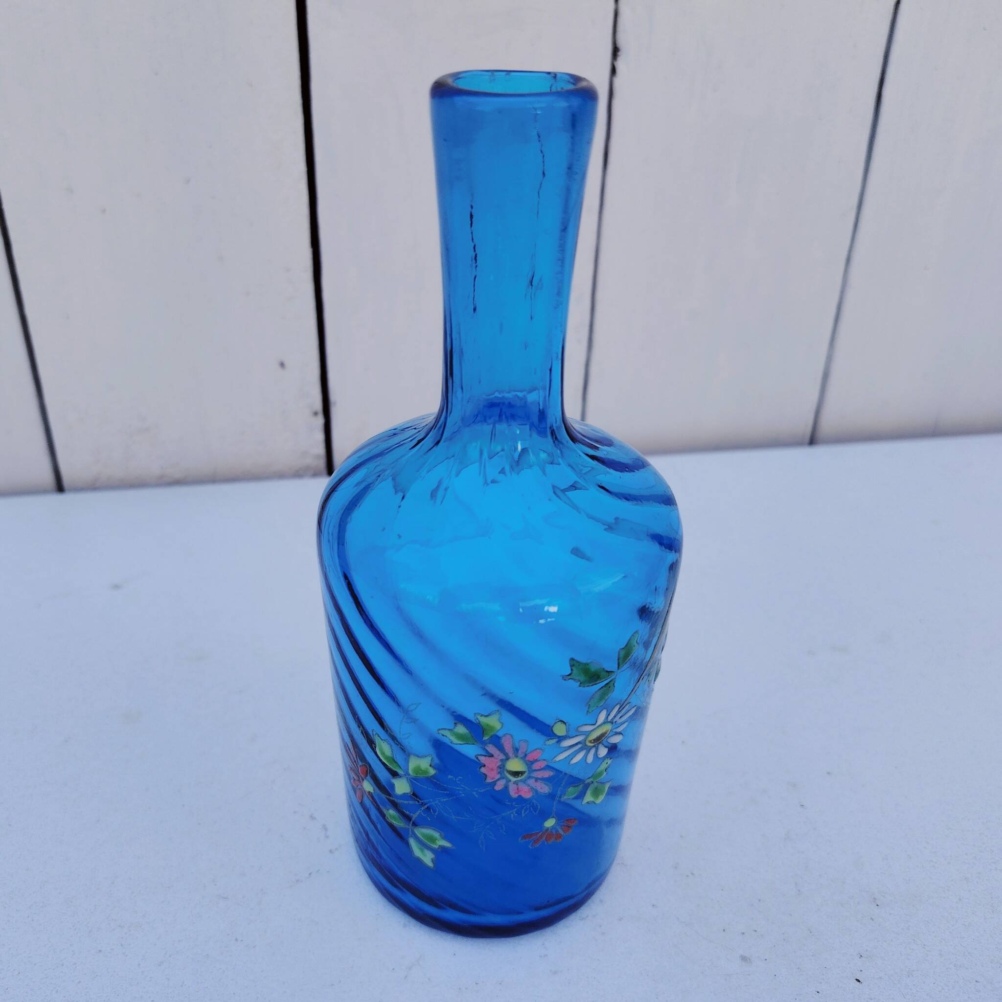 Vintage twisted blue glass carafe with enamel decoration.