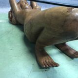 Low table, exotic wooden footing depicting a