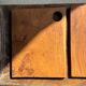 Small rectangular teak monoxyle cutting board with a circular handle.