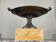 Bronze cup on a yellow Siena marble base, early 19th century.