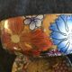 Porcelain candy with enamelled floral decorations. Pretty colors on a golden background.