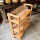 Folding bookshelf in light wood.