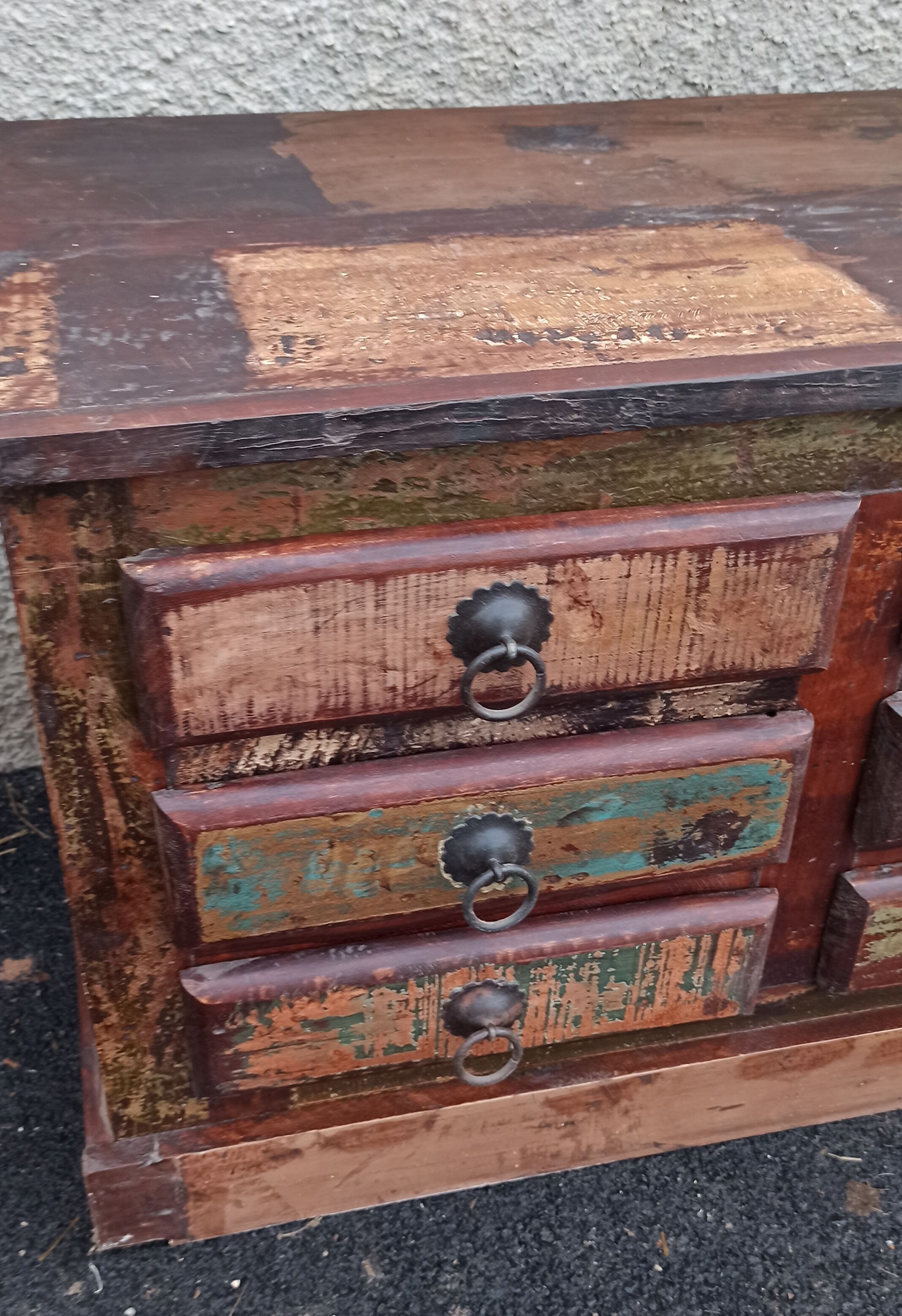 Furniture low in colorful wood. 12 drawers and 1 door