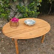 Folding drop-leaf table made of raw solid wood.