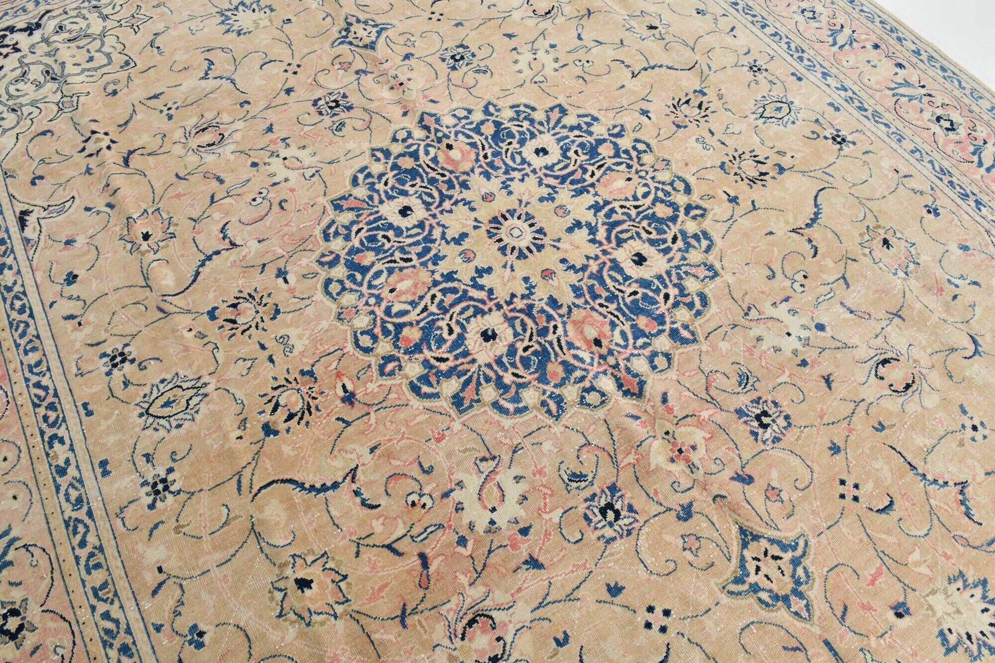 Antique Turkish wool rug in faded floral patterns, 10 x 13 feet.