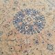 Antique Turkish wool rug in faded floral patterns, 10 x 13 feet.