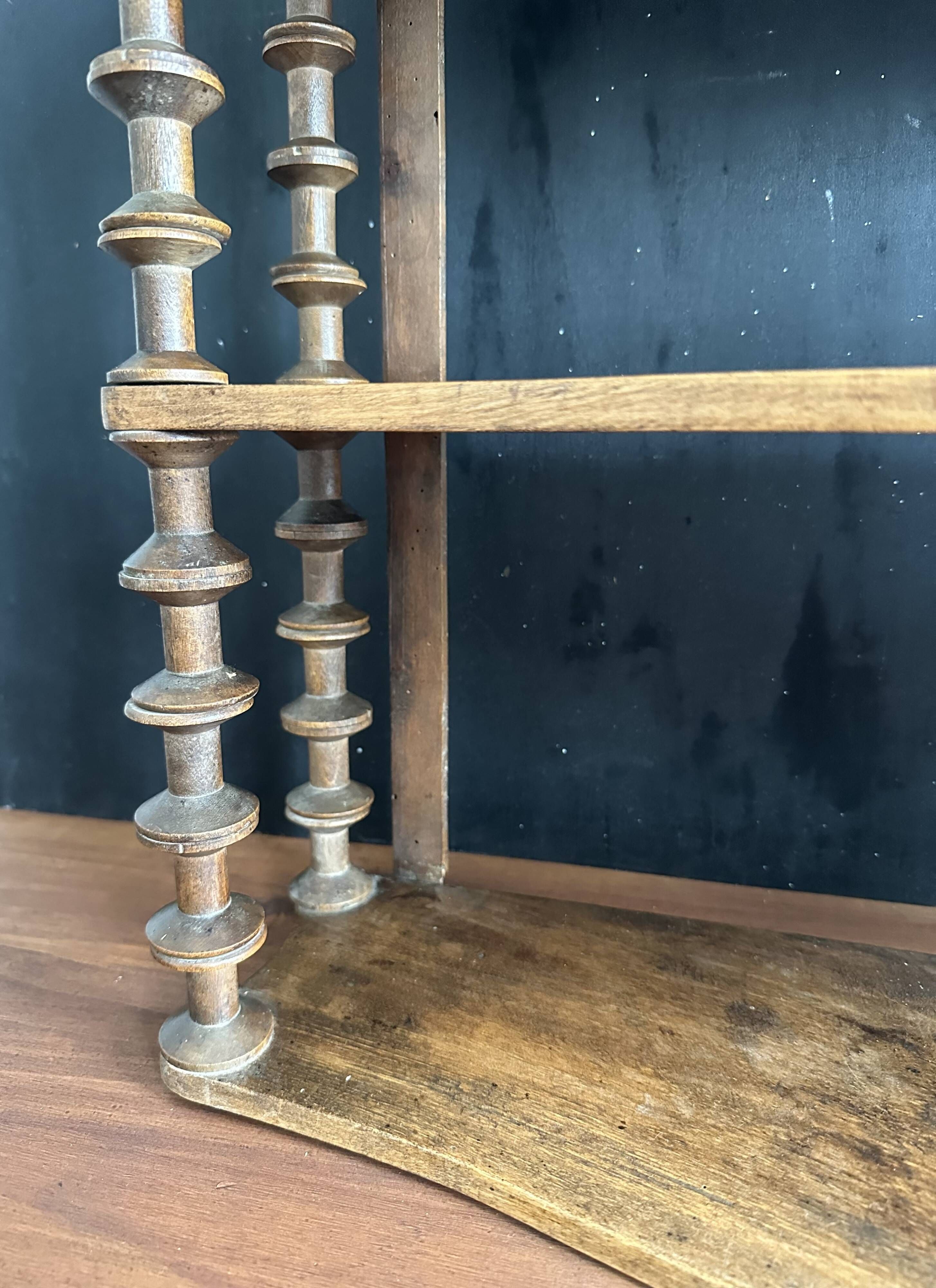 Antique wall shelf made of turned wood and spools of thread, late 19th century.