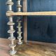 Antique wall shelf made of turned wood and spools of thread, late 19th century.