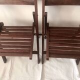 Pair of folding chairs in dark wooden slats