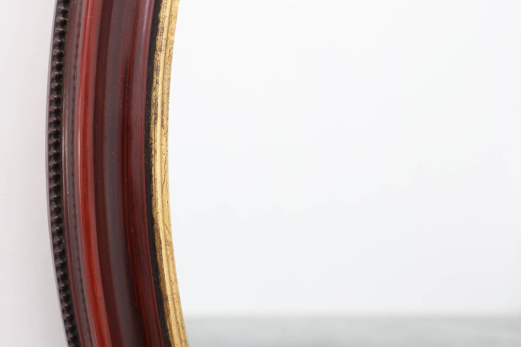 French Burgundy Lacquered Oval Mirror with Gilt Inner Edge, circa 1920