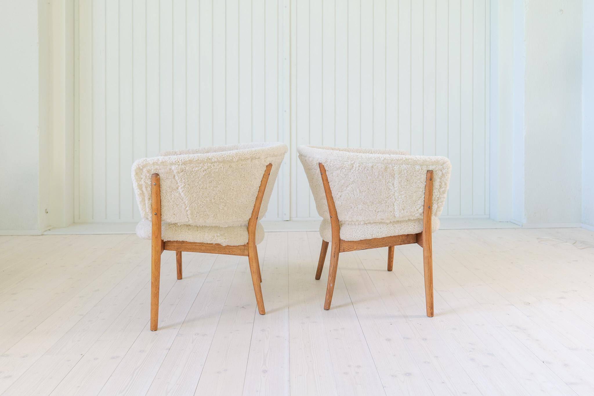 Mid-century lounge chairs in sheepskin/shearling and stained wood, Sweden, 1962.
