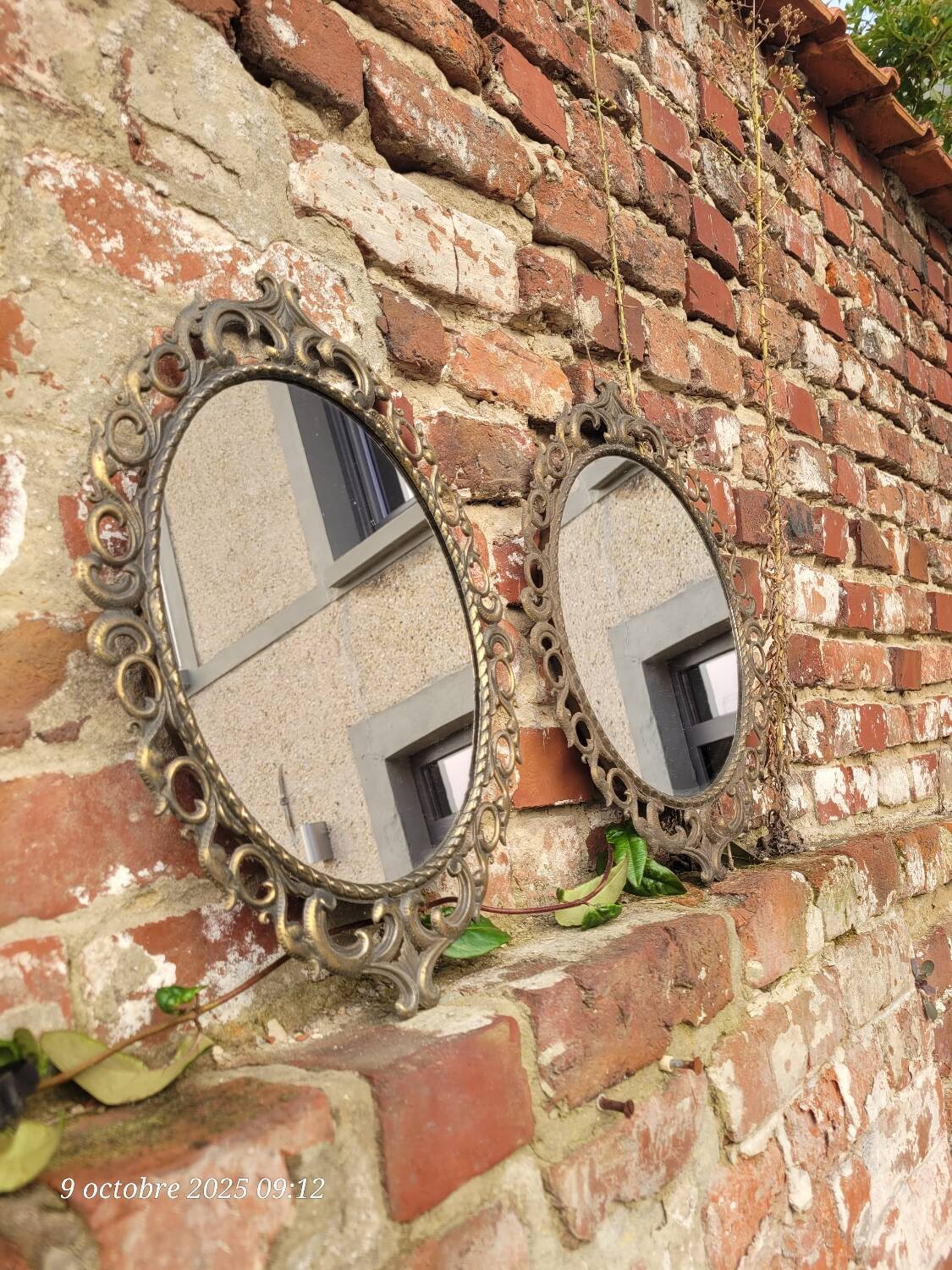2 antique oval mirrors in heavy metal