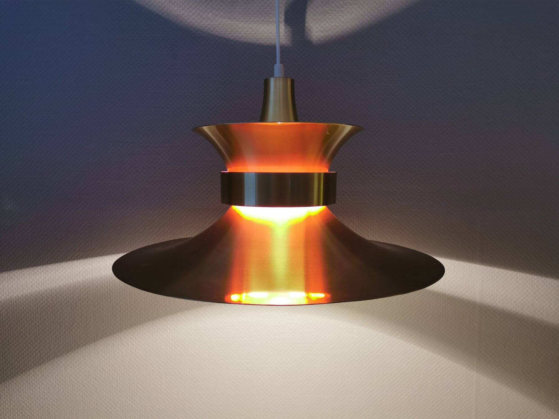 Large hanging lamp, made of brass-coloured aluminium with red and white contrast lacquer inside.