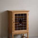 Scandinavian wardrobe in natural oak with a glass front.