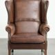 Cowhide wingback armchair in English style finished with decorative nails