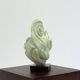 Green natural stone sculpture on marble base