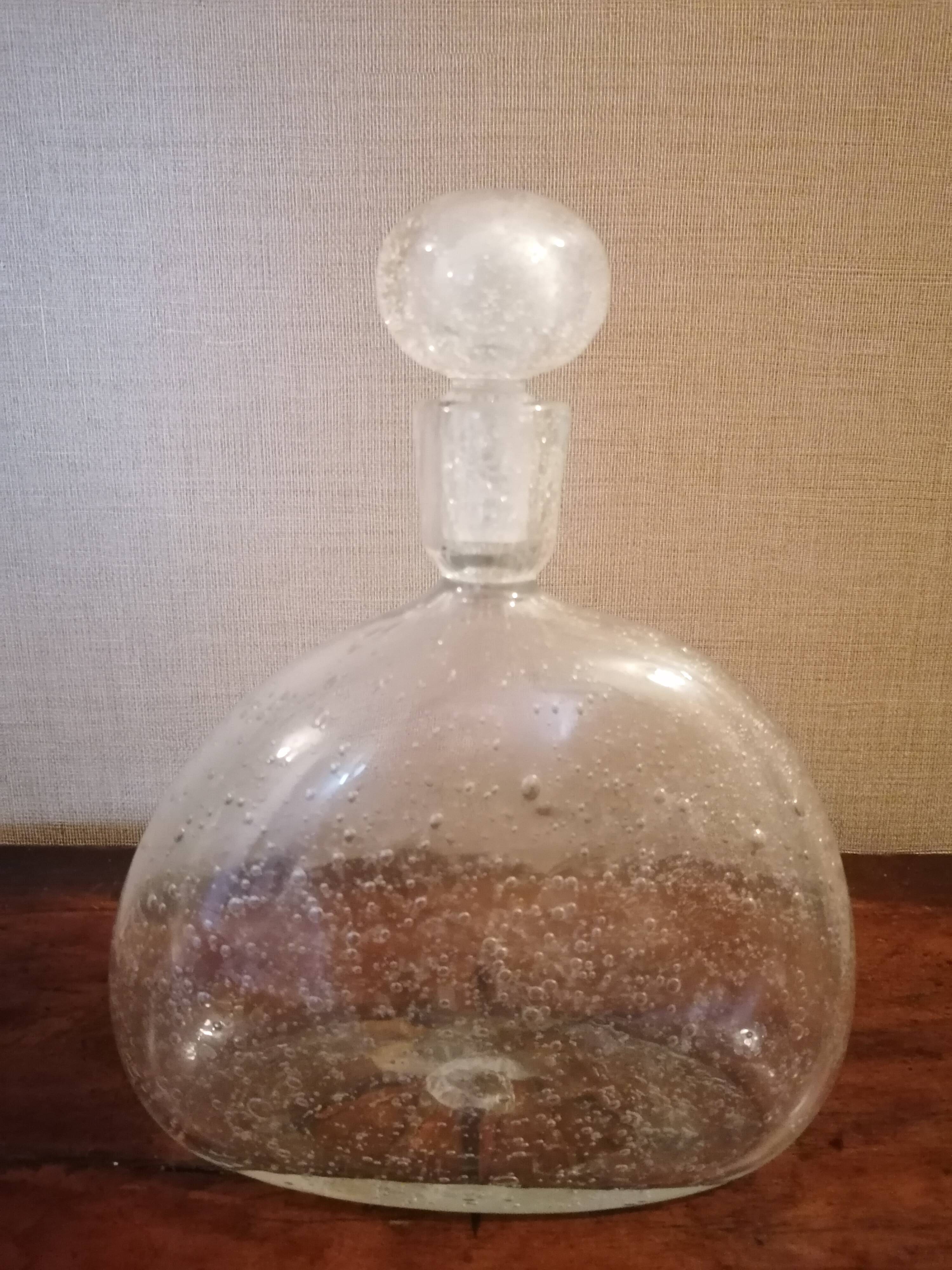 Clear bubble glass bottle molded for easy manual gripping