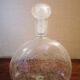 Clear bubble glass bottle molded for easy manual gripping