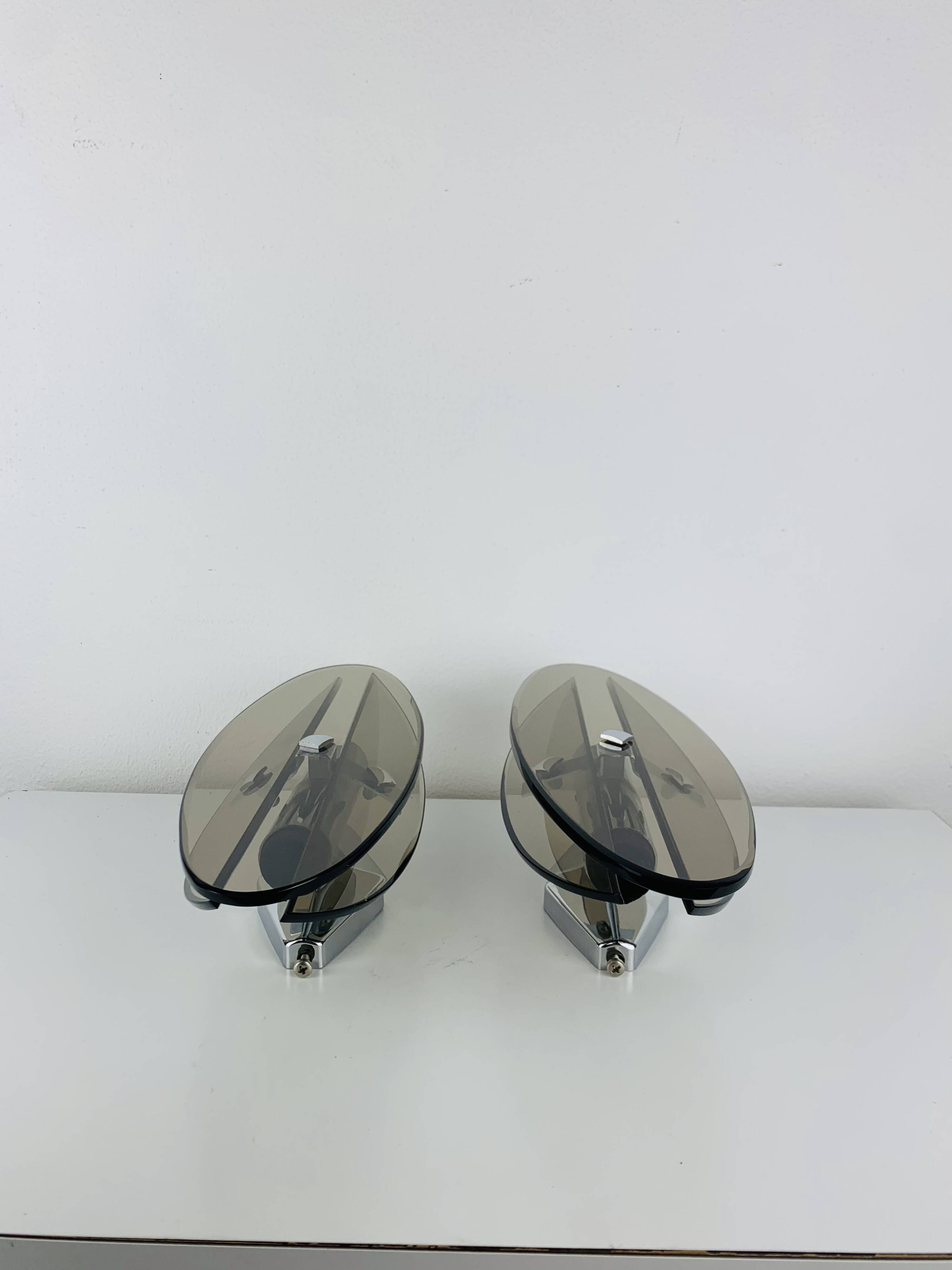 Pair of smoked glass and chrome wall lights from the 1970s.