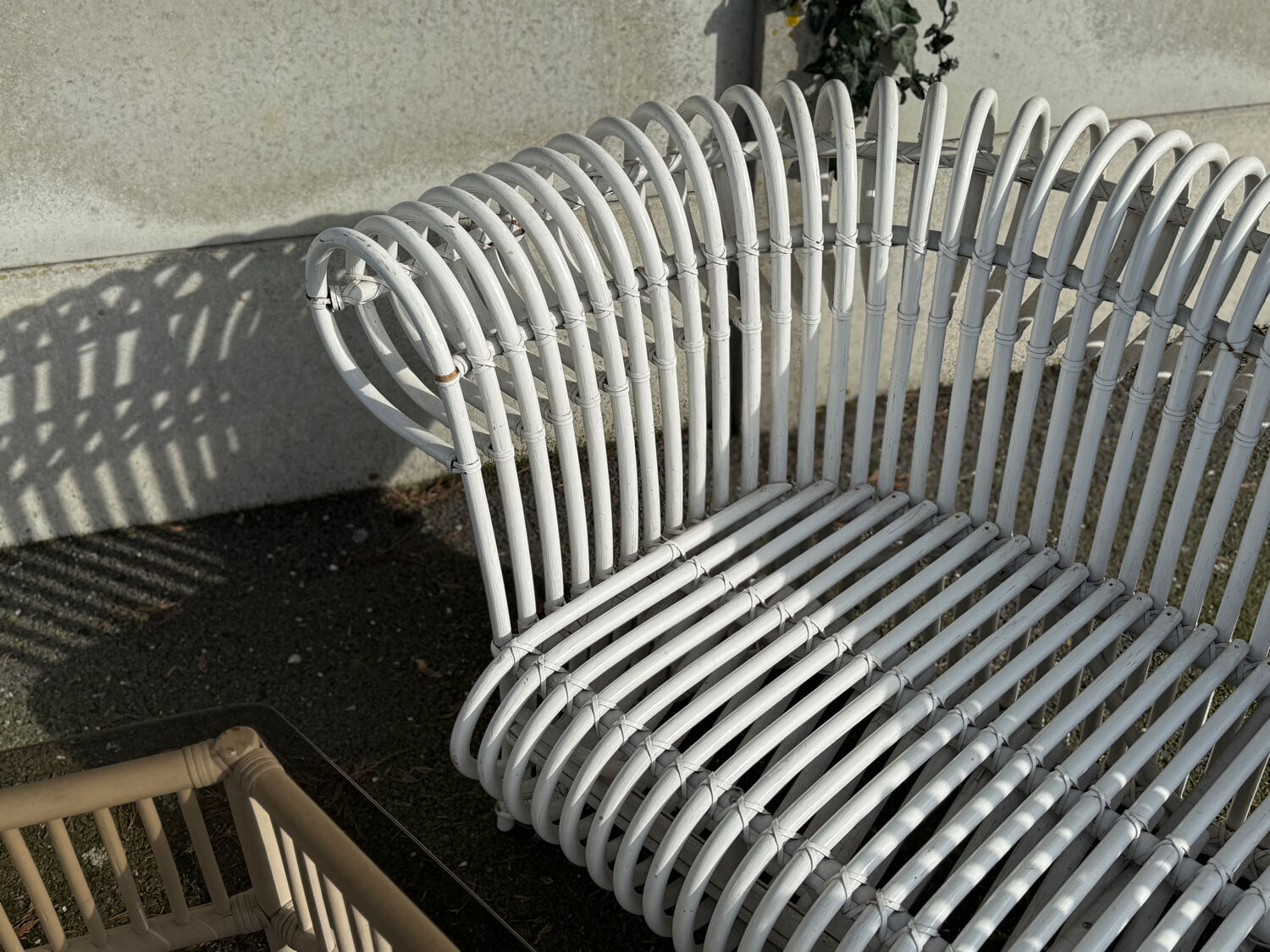 Rattan lounge with two two-seater sofas and a white coffee table.