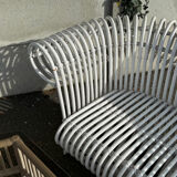 Rattan lounge with two two-seater sofas and a white coffee table.