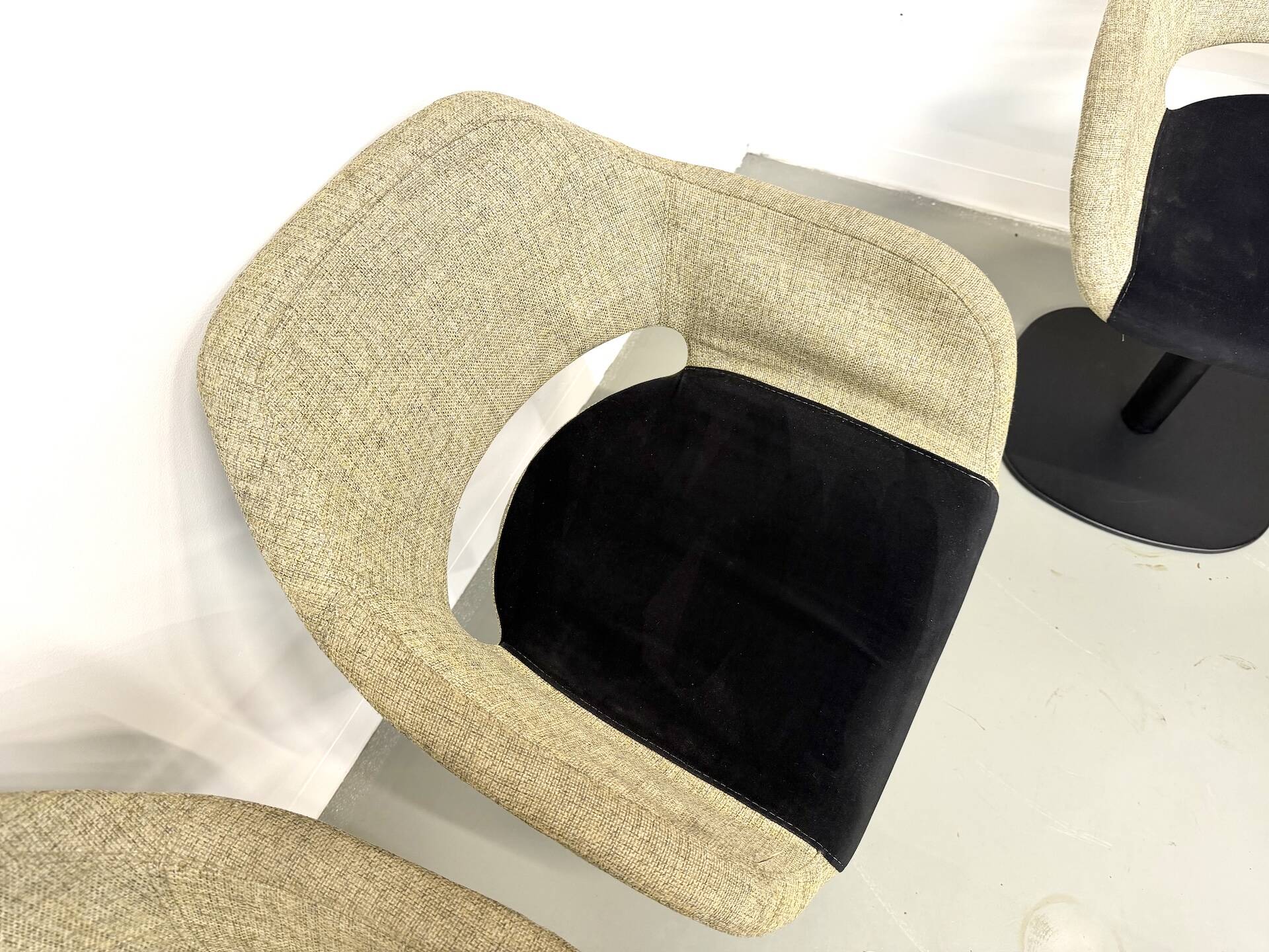 Series of six swivel chairs with an organic shell, patterned fabric and base.