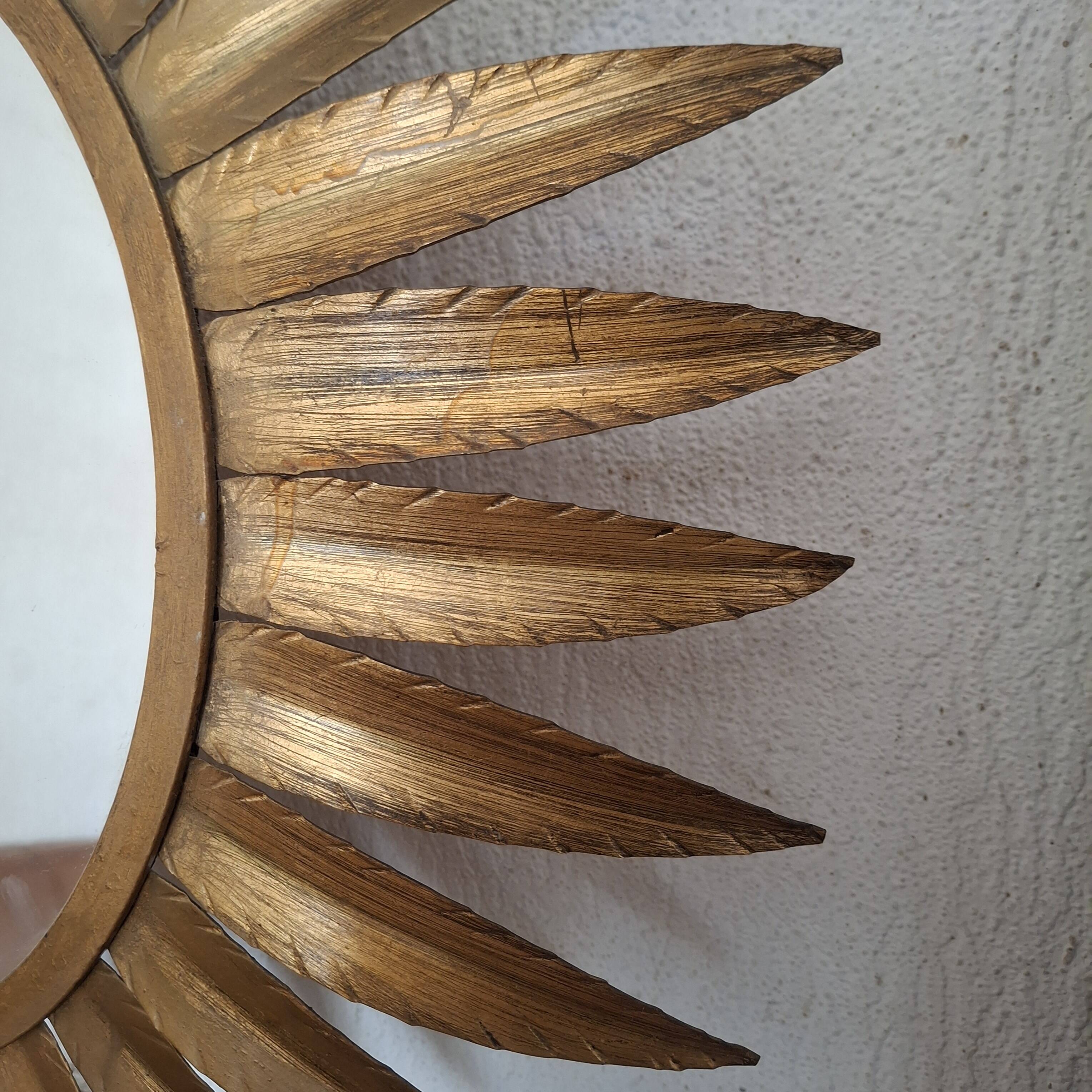 Large sun mirror in gilded metal. 1960