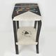 Table topped with a ceramic mosaic featuring an abstract design.