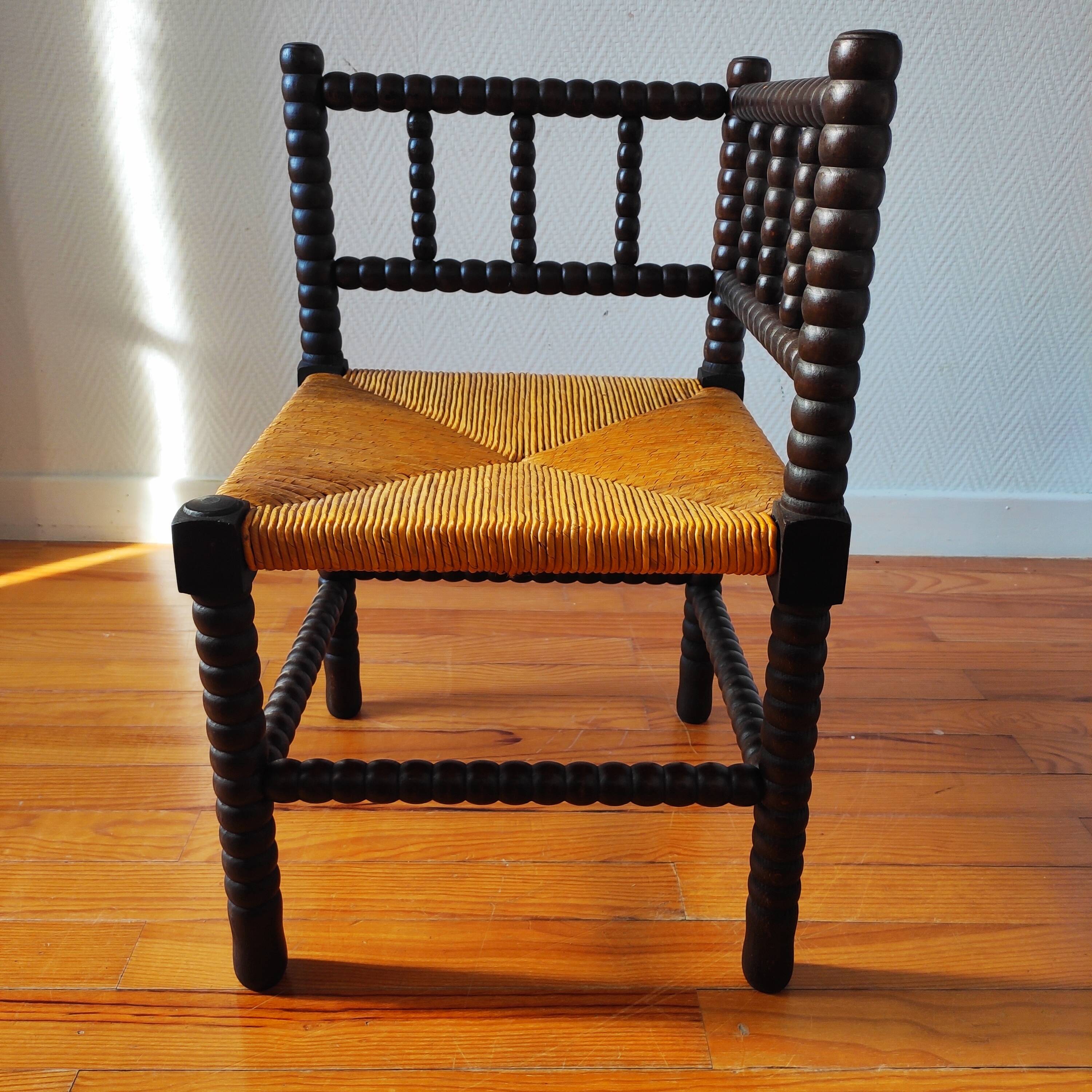 Antique corner chair made of turned wood.