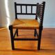 Antique corner chair made of turned wood.