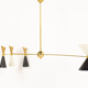 8-light brass chandelier and white-black and gold day blinds