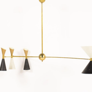8-light brass chandelier and white-black and gold day blinds