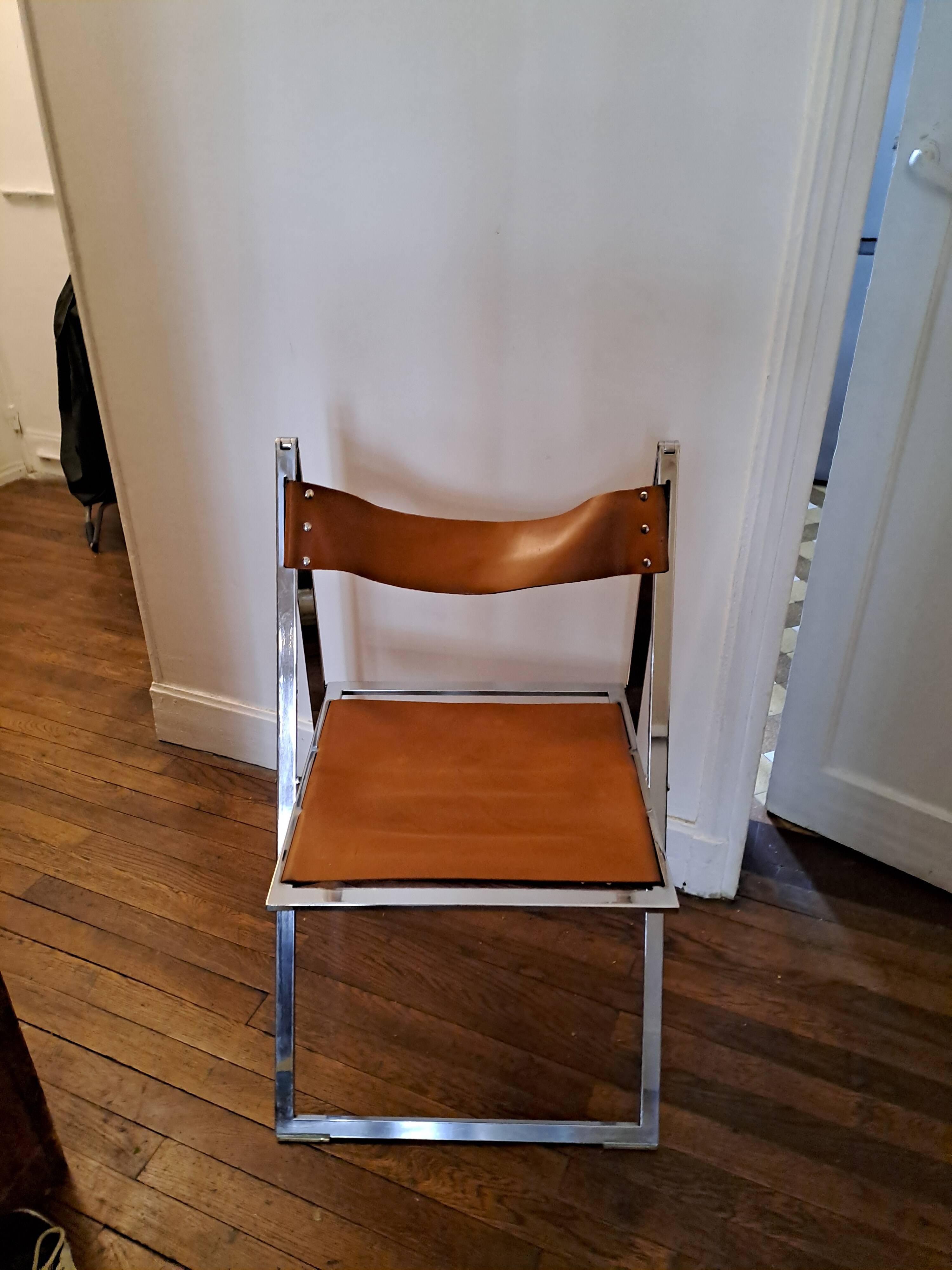 2 Chromed metal and leather folding chairs. 70s. Fontoni & Geraci
