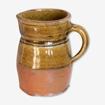 Old pitcher in glazed terracotta