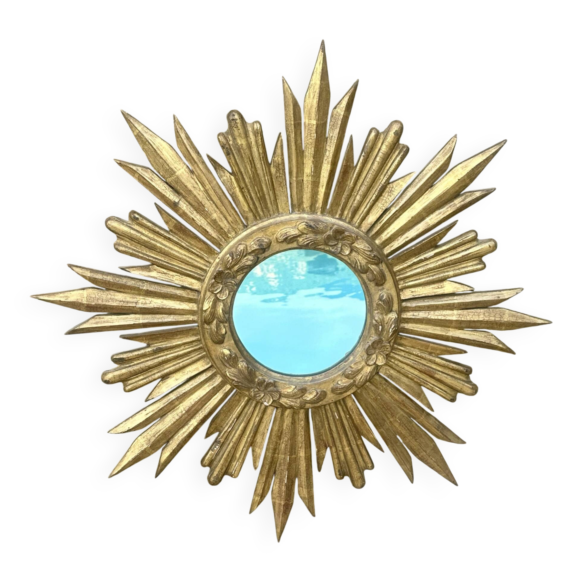 Large sun mirror in carved gilded wood.