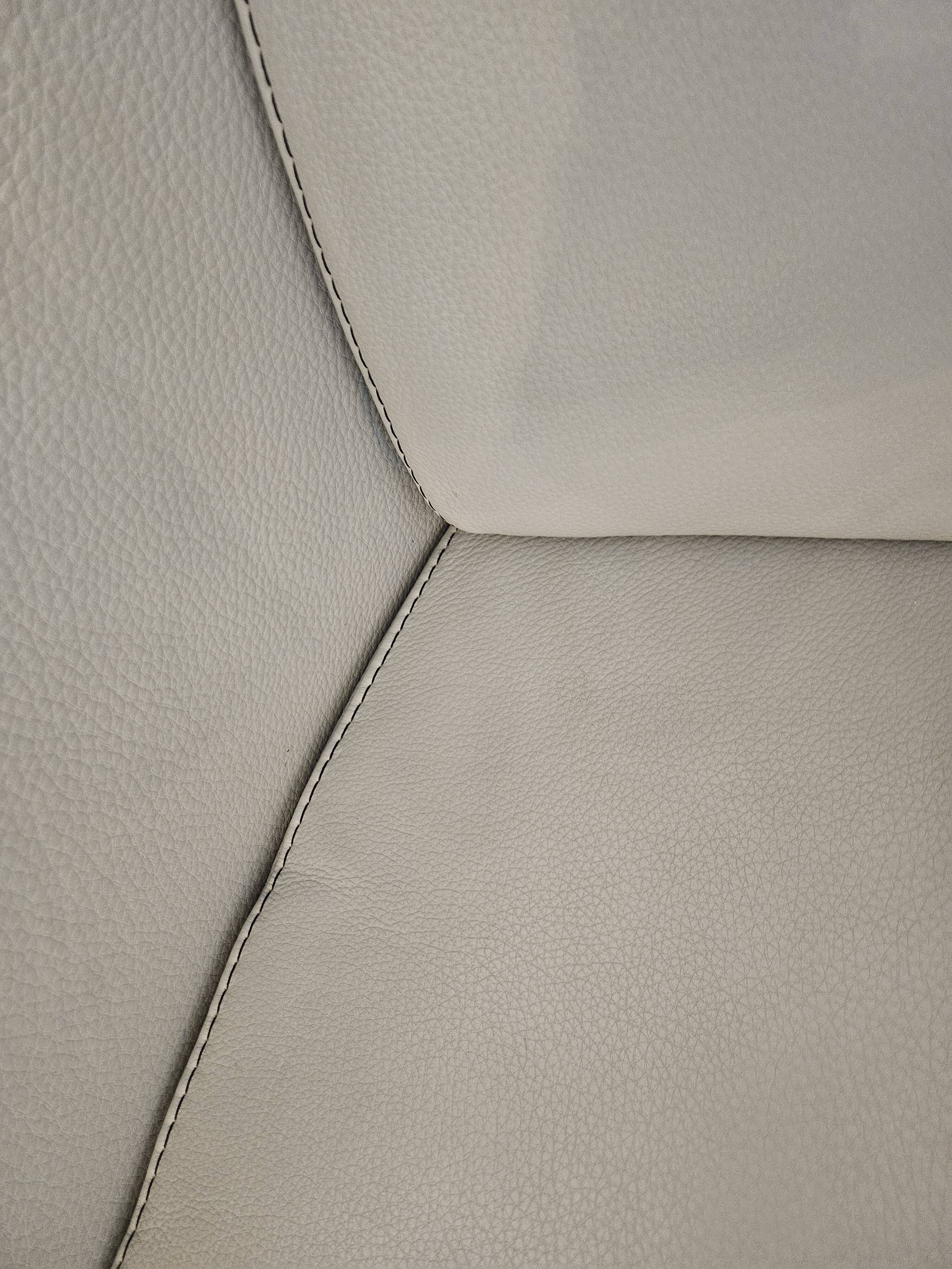 Two-seater sofa and a grey leather armchair Italia.