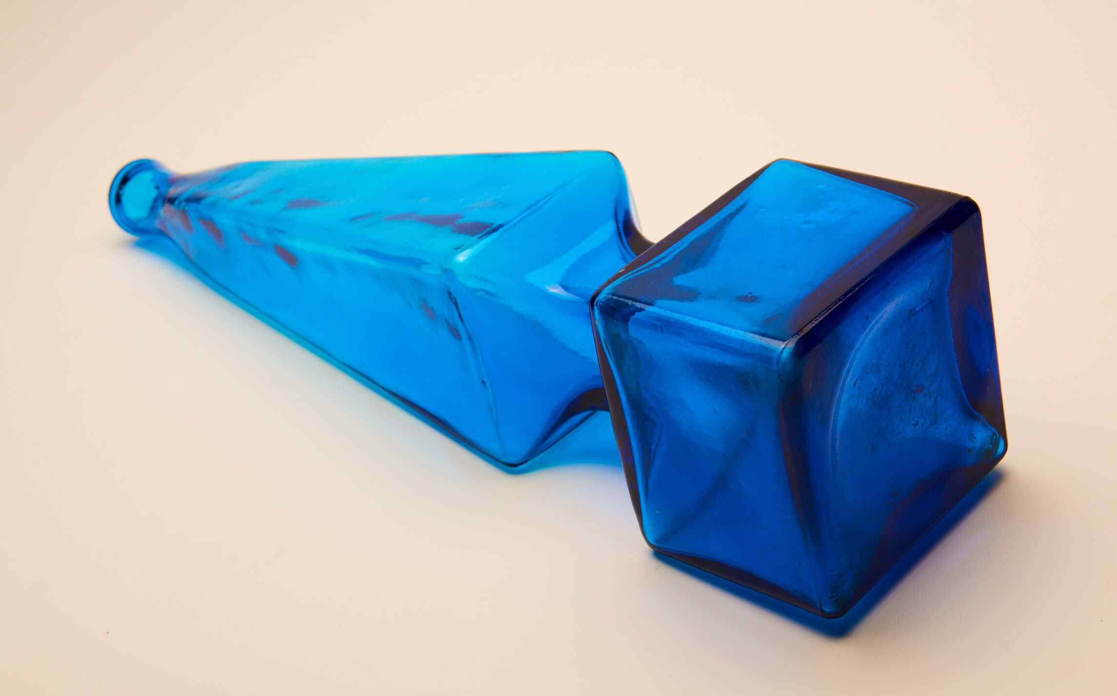 large blue glass obelisk-shaped bottle or vase