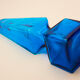 large blue glass obelisk-shaped bottle or vase
