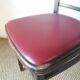 Set of 19 vintage wooden bistro chairs with red faux leather.