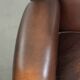Subtle sheepskin wingback armchair with a deep cognac colour