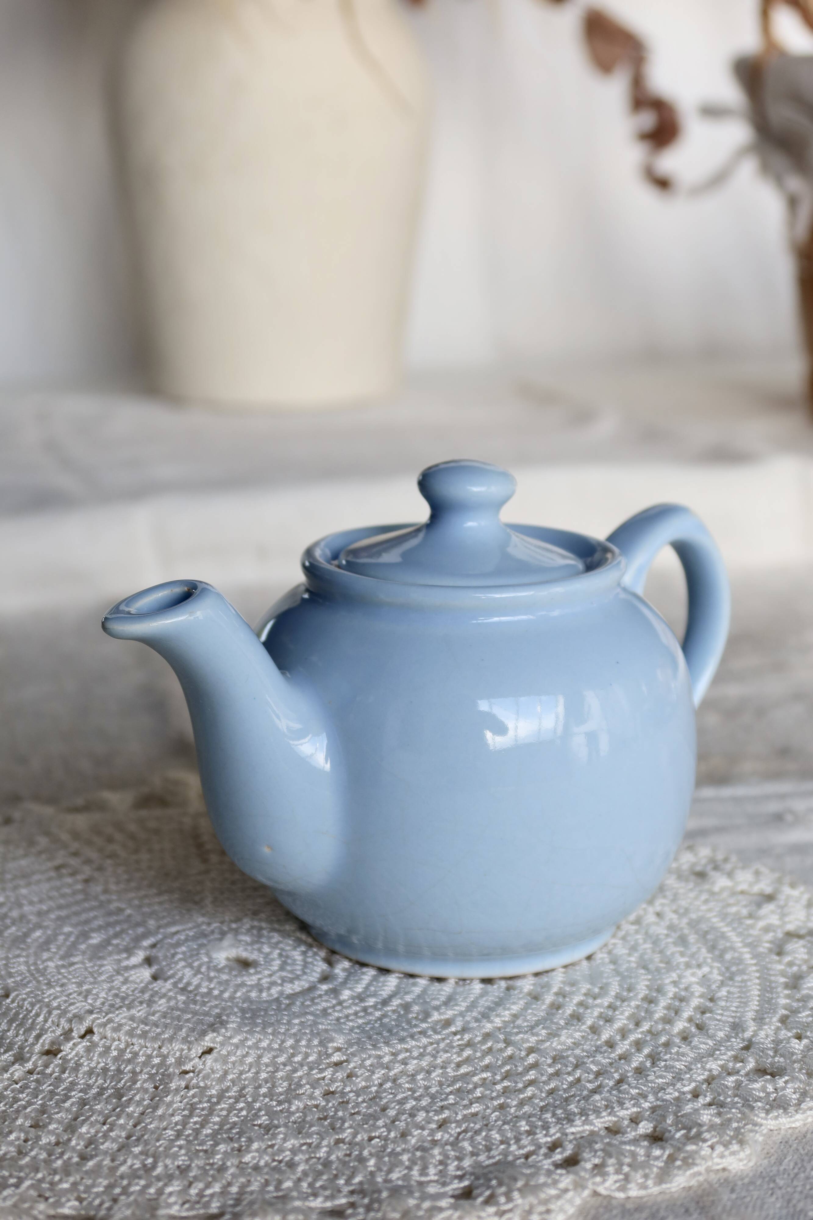 Small vintage sky-blue earthenware teapot