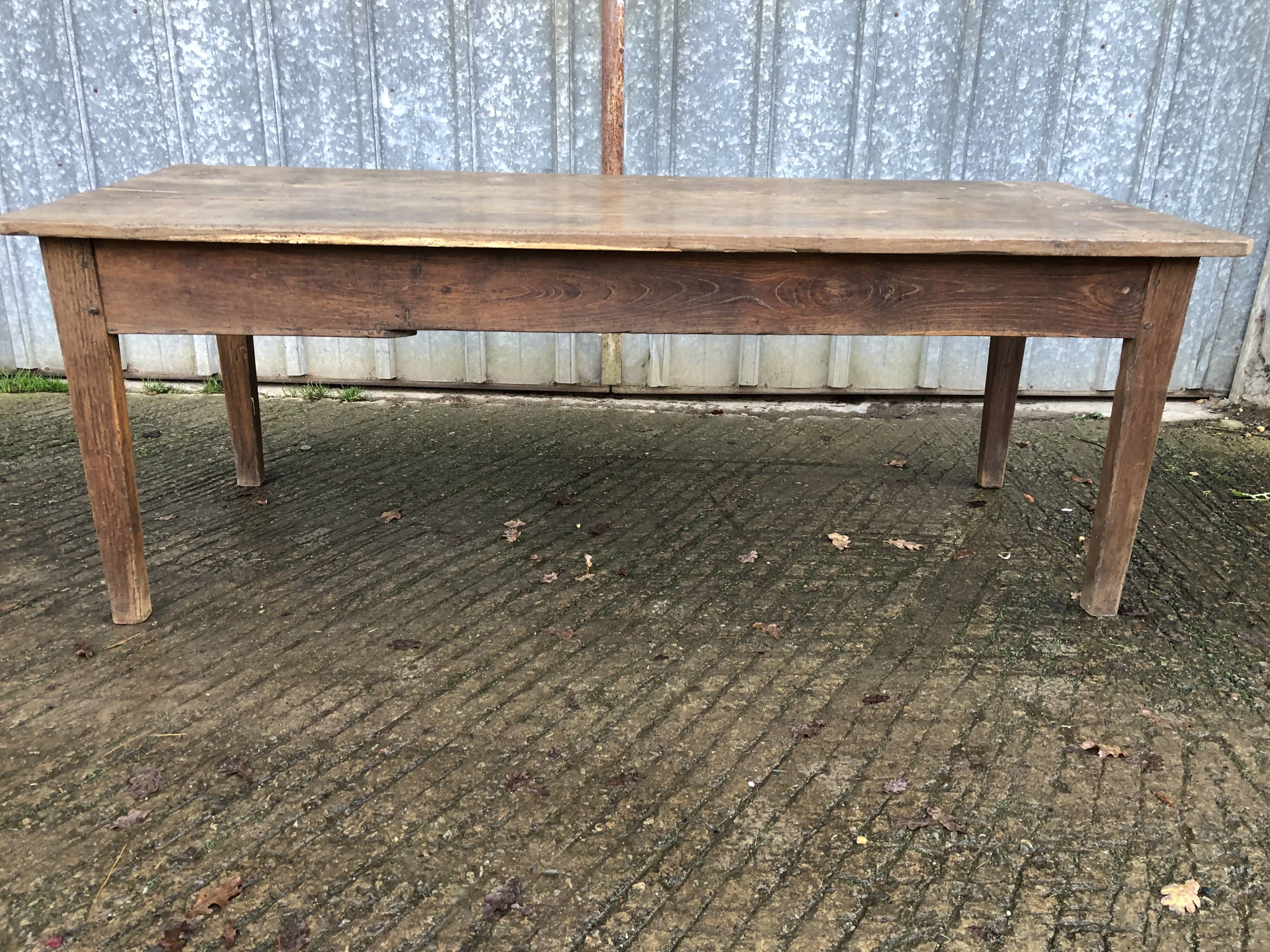 Antique farmhouse table in solid oak with tapered legs and 1 drawer at the end.