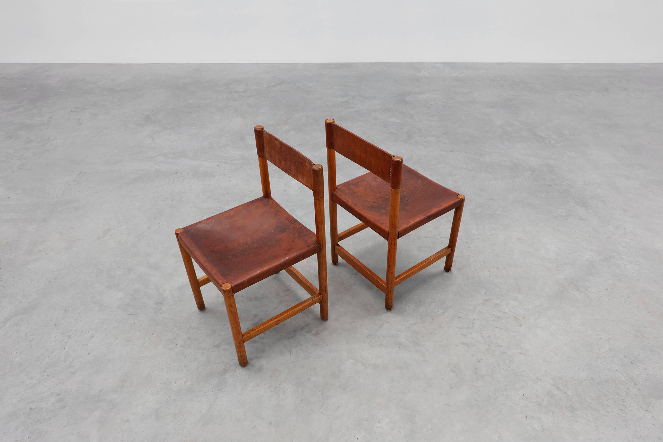 Pair of wood and leather Spanish chairs by Jordi Vilanova, ca. 1960