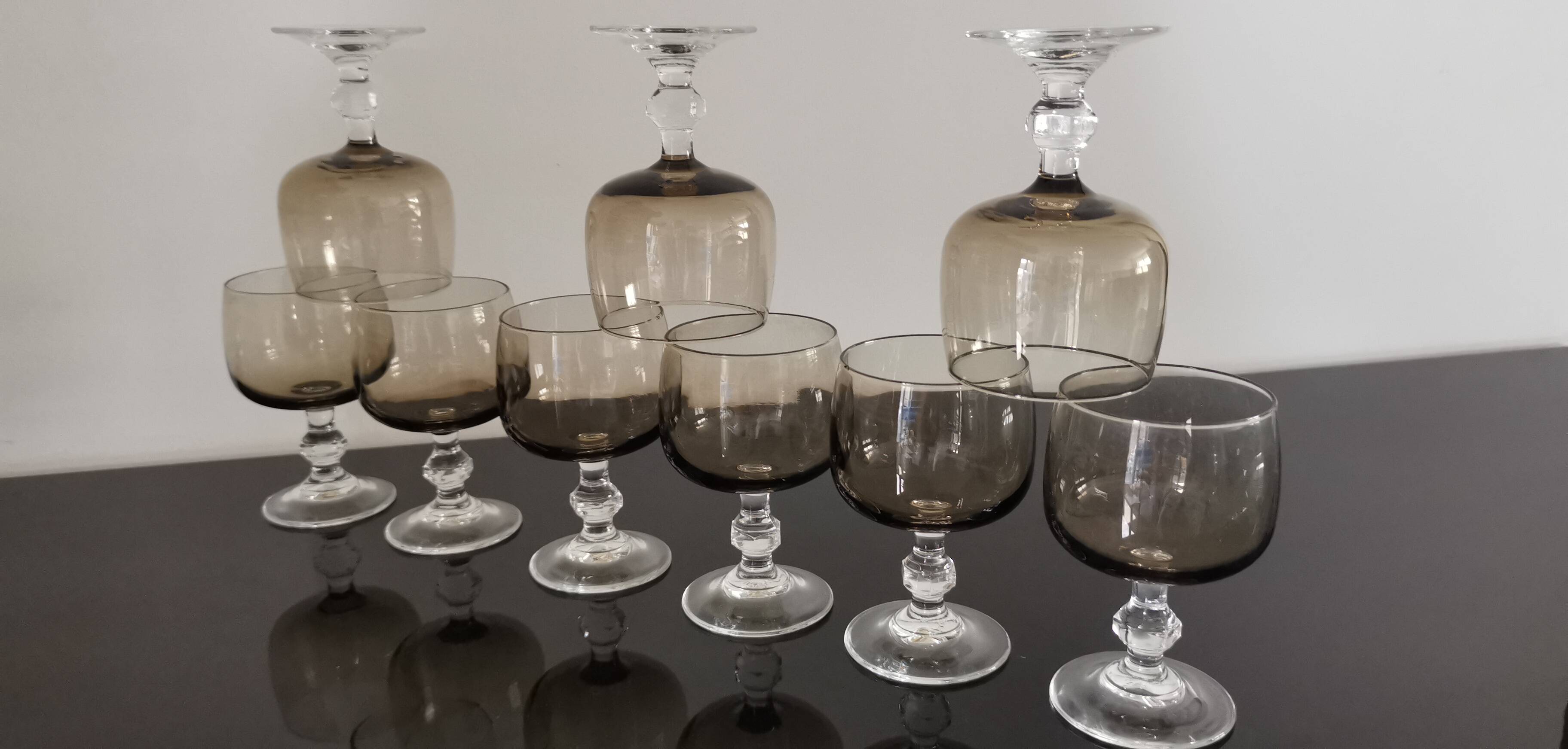 9 white wine glasses on vintage Luminarc smoked black stem