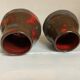 Pair of red vases in the shape of an elephant's foot