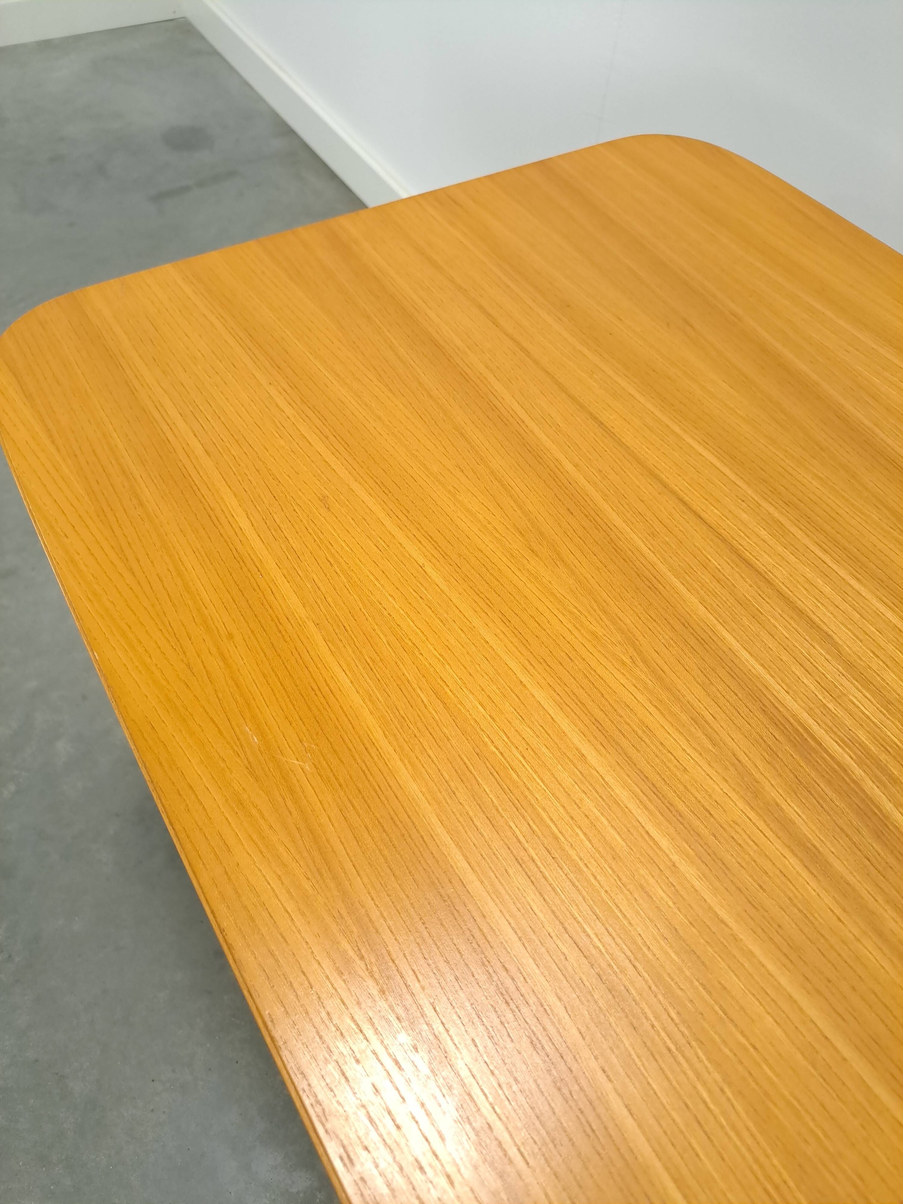 Vintage veneer table with pretty angular legs and brass at the base of the legs.