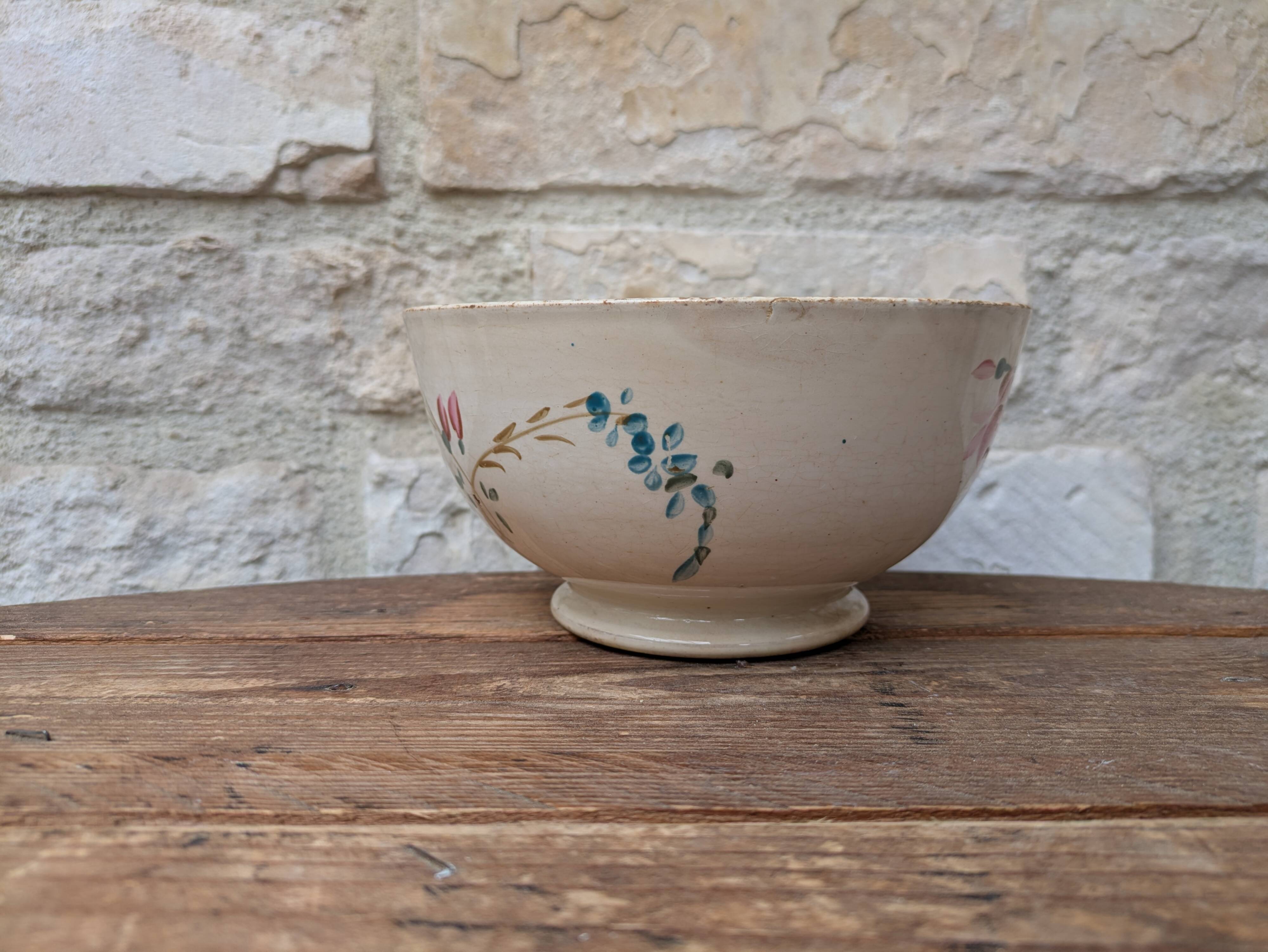 Old opaque porcelain bowl from Gien with a floral decoration.