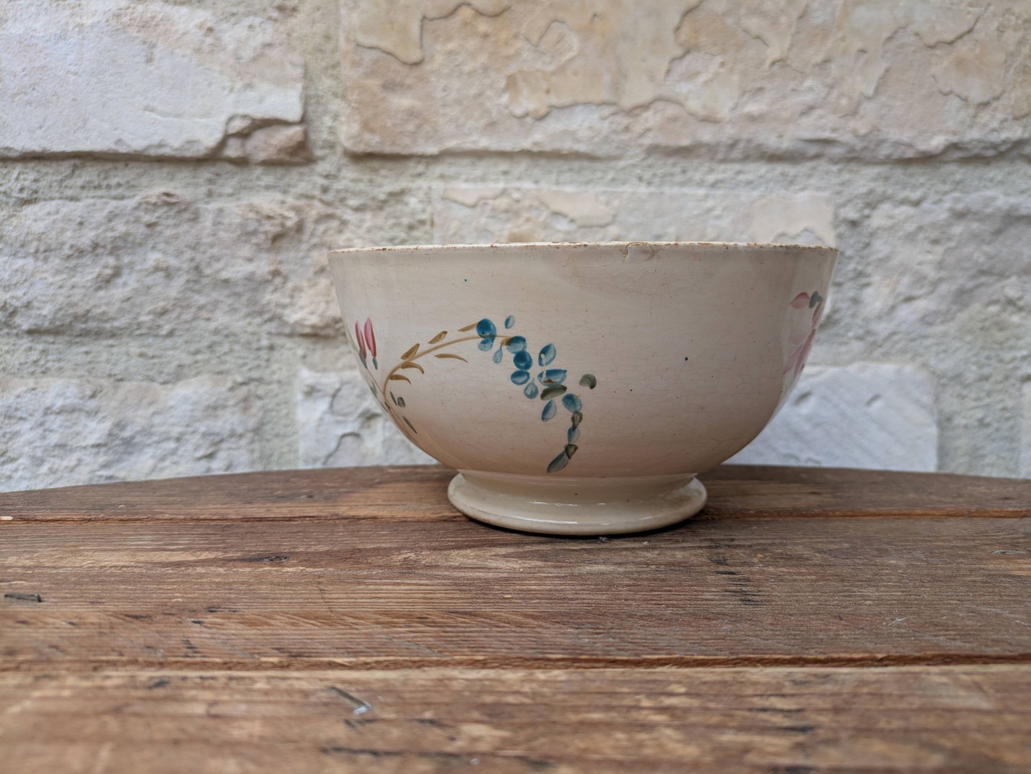 Old opaque porcelain bowl from Gien with a floral decoration.