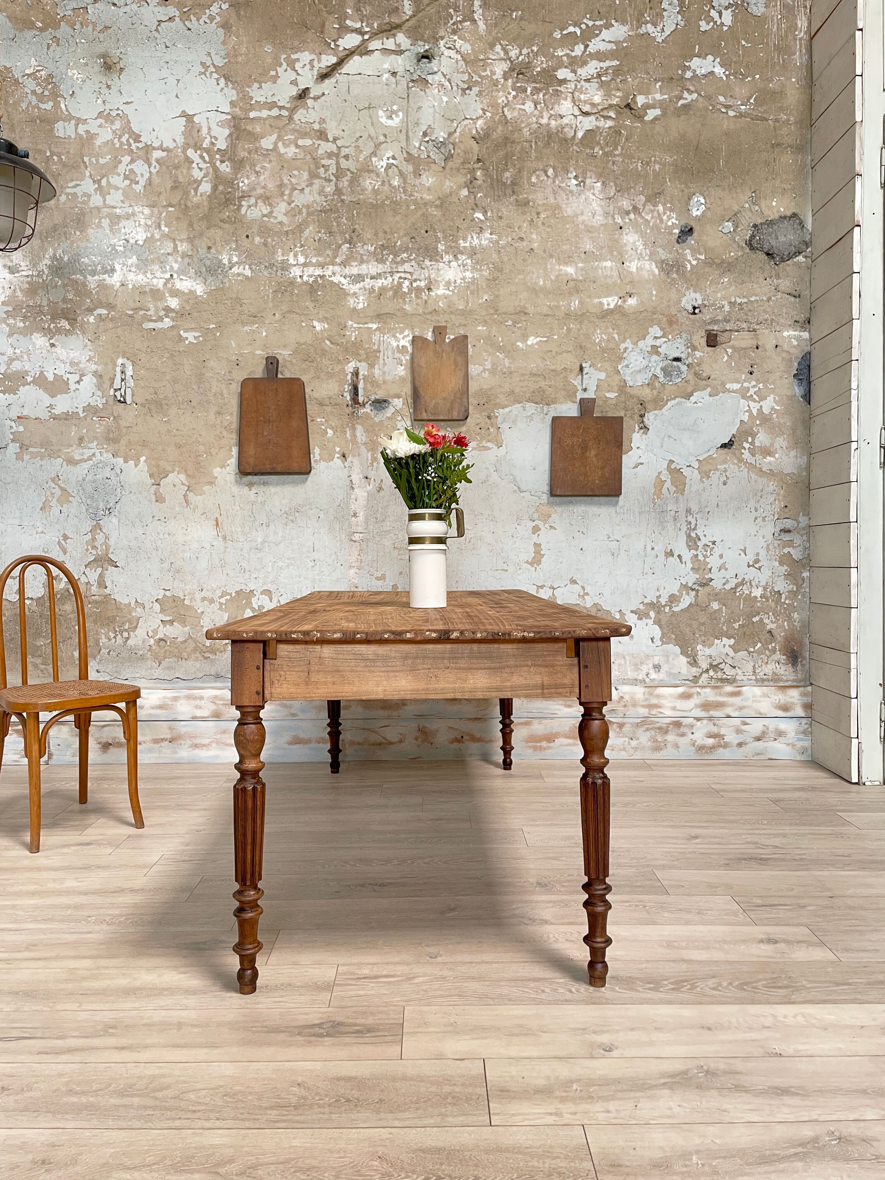 Vintage farmhouse table with turned legs.